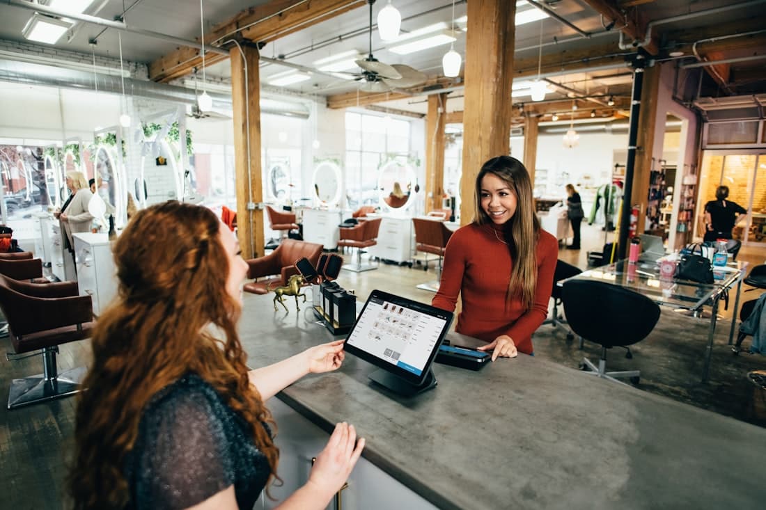 A business owner reviewing finances at their shop counter.
